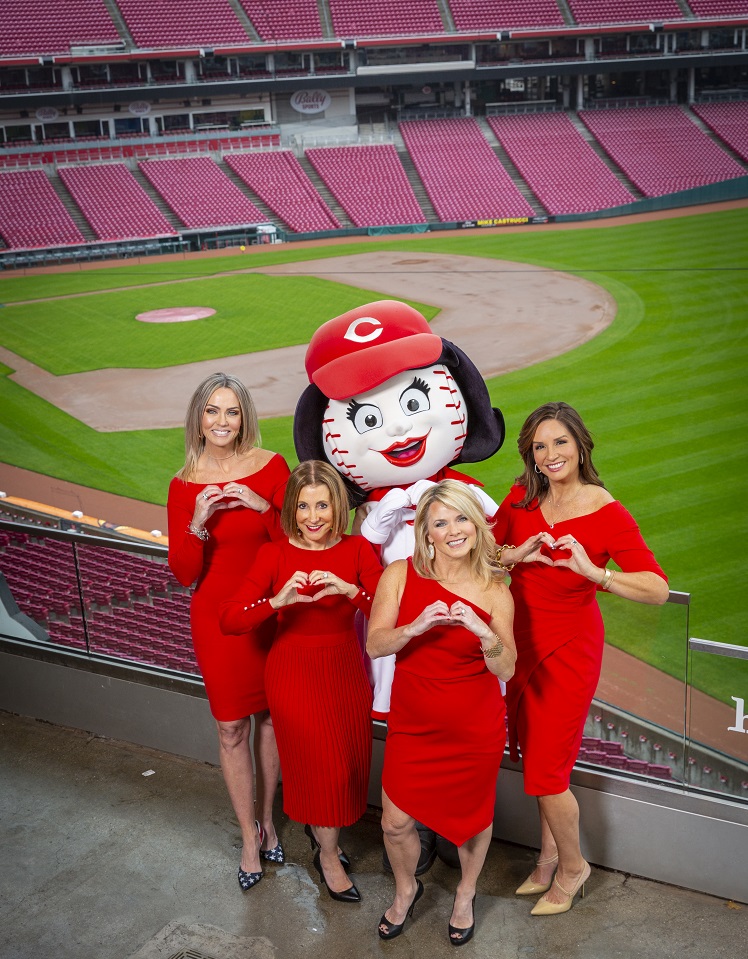 Four women in red with baseball mascot